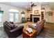 Inviting living room featuring a fireplace, ceiling fan, and french doors to the exterior at 11945 Darwin Ave, New Port Richey, FL 34654