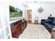Relaxing living room featuring a television, hardwood flooring, and furniture at 11945 Darwin Ave, New Port Richey, FL 34654