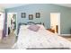 Bright main bedroom with ensuite access, featuring hardwood floors and neutral tones, creating a relaxing retreat at 11945 Darwin Ave, New Port Richey, FL 34654