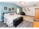 Spacious main bedroom with a sitting area, wood floors, and a comfortable bed for relaxation at 11945 Darwin Ave, New Port Richey, FL 34654
