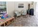 Covered outdoor patio with brick flooring and comfortable seating creates an inviting retreat at 11945 Darwin Ave, New Port Richey, FL 34654
