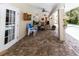 Covered patio with brick flooring, ceiling fans, and a clear view of the backyard and pool at 11945 Darwin Ave, New Port Richey, FL 34654