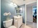 Clean bathroom showing a vanity, toilet, lighting and doorway to the main bedroom at 1207 Pine Ridge W Cir # H2, Tarpon Springs, FL 34688