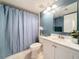 Well-maintained bathroom with a shower and blue shower curtain at 1207 Pine Ridge W Cir # H2, Tarpon Springs, FL 34688