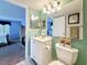 A view from the bathroom into the bedroom showcasing the ensuite layout at 1207 Pine Ridge W Cir # H2, Tarpon Springs, FL 34688