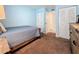 A nicely decorated bedroom showing the ensuite bathroom and closet at 1207 Pine Ridge W Cir # H2, Tarpon Springs, FL 34688