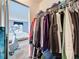 A look through a closet showing the organization and space with a glimpse of the main bedroom at 1207 Pine Ridge W Cir # H2, Tarpon Springs, FL 34688
