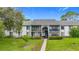 Inviting two-story condo with well-manicured lawn and access stairs to the upper units at 1207 Pine Ridge W Cir # H2, Tarpon Springs, FL 34688