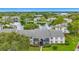 An exterior view overlooking a pond and trees with a condo building and neatly trimmed green space at 1207 Pine Ridge W Cir # H2, Tarpon Springs, FL 34688