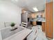 Eat-in kitchen features stainless steel appliances, wood cabinetry, and a cozy dining area at 1207 Pine Ridge W Cir # H2, Tarpon Springs, FL 34688