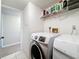 Bright laundry room featuring a Samsung washer and dryer with tile floors at 1207 Pine Ridge W Cir # H2, Tarpon Springs, FL 34688