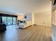 Spacious living room, features modern furniture, balcony access, and ample natural light at 1207 Pine Ridge W Cir # H2, Tarpon Springs, FL 34688