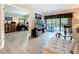 Comfortable living room with a view to a balcony and connecting office space, perfect for work and relaxation at 1207 Pine Ridge W Cir # H2, Tarpon Springs, FL 34688