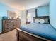 Comfortable main bedroom featuring natural light, a wood bed frame and nice furnishings at 1207 Pine Ridge W Cir # H2, Tarpon Springs, FL 34688