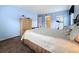 Comfortable main bedroom featuring blue walls, dresser and a doorway to the main bathroom at 1207 Pine Ridge W Cir # H2, Tarpon Springs, FL 34688