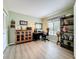 A home office features a desk, bookcase, and ample natural light at 1207 Pine Ridge W Cir # H2, Tarpon Springs, FL 34688