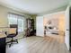 A home office flows into the living room, providing ample space and natural light at 1207 Pine Ridge W Cir # H2, Tarpon Springs, FL 34688