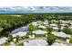 Aerial view of the community, serene water, lush trees, and community homes at 123 Glendower Cir # 123, Sun City Center, FL 33573