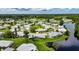 Aerial view of a well-maintained community with lush landscaping, water features, and golf course at 123 Glendower Cir # 123, Sun City Center, FL 33573