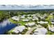 Community aerial view with serene water, lush trees, and community homes at 123 Glendower Cir # 123, Sun City Center, FL 33573