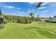 Lush backyard view of the water, trees and neighboring houses under a bright sky at 123 Glendower Cir # 123, Sun City Center, FL 33573