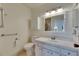 Clean bathroom with updated vanity, white cabinets and walls, and classic fixtures at 123 Glendower Cir # 123, Sun City Center, FL 33573