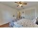 Bedroom with wood flooring, a ceiling fan, a double closet, and white dresser at 123 Glendower Cir # 123, Sun City Center, FL 33573
