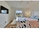 A modern and bright bedroom featuring hardwood floors, and a ceiling fan to keep the space cool at 123 Glendower Cir # 123, Sun City Center, FL 33573