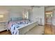 Bright bedroom with hardwood floors, ceiling fan, and a view to the Primary bathroom at 123 Glendower Cir # 123, Sun City Center, FL 33573