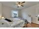 Bright bedroom with wood flooring, ceiling fan, and a large window providing natural light at 123 Glendower Cir # 123, Sun City Center, FL 33573