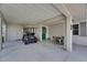 Spacious carport with golf cart and seating area adjacent to the front door of the house at 123 Glendower Cir # 123, Sun City Center, FL 33573