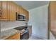 Updated kitchen with stainless steel appliances, granite countertops and white subway tile backsplash at 123 Glendower Cir # 123, Sun City Center, FL 33573