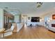 Bright living room featuring wood floors, an open floor plan, and natural light at 123 Glendower Cir # 123, Sun City Center, FL 33573