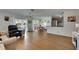Open-concept living space with wood floors, a dining area, stainless steel appliances, and outdoor access at 123 Glendower Cir # 123, Sun City Center, FL 33573