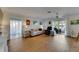 Spacious living room with wood floors, plenty of natural light, and comfortable seating areas at 123 Glendower Cir # 123, Sun City Center, FL 33573