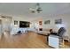 Expansive living room featuring wood floors, a ceiling fan, and comfortable seating arrangements at 123 Glendower Cir # 123, Sun City Center, FL 33573