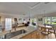 Bright open floor plan combining kitchen, dining, and living areas with a ceiling fan and outside views at 123 Glendower Cir # 123, Sun City Center, FL 33573