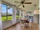 Bright sunroom with large windows, ceiling fan, and a view of the well-manicured lawn at 123 Glendower Cir # 123, Sun City Center, FL 33573