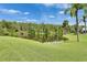 Tranquil water view with lush trees and grass under a sunny sky at 123 Glendower Cir # 123, Sun City Center, FL 33573