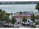 Exterior view of a Columbia restaurant featuring palm trees and a water view in the background at 1230 Gulf Blvd # 601, Clearwater Beach, FL 33767