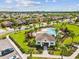 Aerial view of a well-planned community with a clubhouse, pool, and meticulously maintained landscaping at 1325 Custer Bayou St, Ruskin, FL 33570