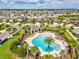 Aerial view showcasing the beautiful pool, clubhouse, and lush landscaping within a well-maintained community at 1325 Custer Bayou St, Ruskin, FL 33570