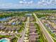 An aerial view shows the community, lakes, nearby roads, and a community pool at 1325 Custer Bayou St, Ruskin, FL 33570