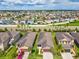An aerial view of homes in the Bayridge community shows well-manicured lawns and mature palm trees at 1325 Custer Bayou St, Ruskin, FL 33570