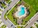 Aerial view of the neighborhood pool, featuring lounge chairs and manicured landscaping for resort-style living at 1325 Custer Bayou St, Ruskin, FL 33570