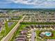 An aerial view shows the community, lakes, nearby roads, and a community pool at 1325 Custer Bayou St, Ruskin, FL 33570