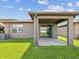 Enjoy the covered patio and lush green lawn in this home's private backyard at 1325 Custer Bayou St, Ruskin, FL 33570