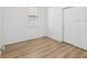 Bedroom featuring light, wood-look floors, and a large window at 1325 Custer Bayou St, Ruskin, FL 33570