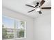 Light and airy bedroom with a ceiling fan and a large window overlooking the neighborhood at 1325 Custer Bayou St, Ruskin, FL 33570