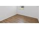 Bedroom featuring light, wood-look floors, and a view from the window at 1325 Custer Bayou St, Ruskin, FL 33570